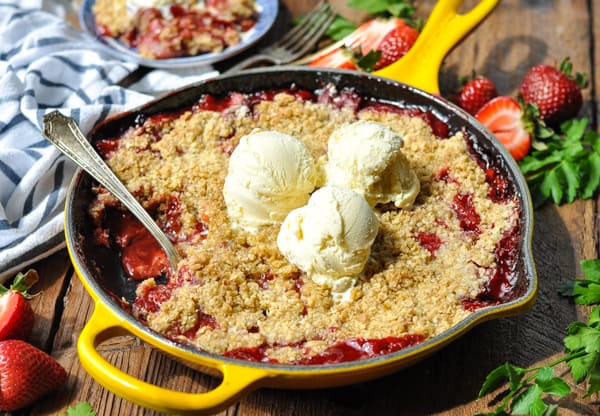 Horizontal shot of strawberry crisp in a cast iron skillet