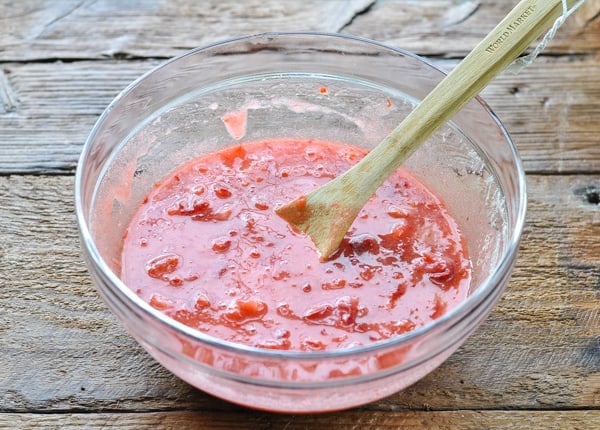 Process shot of mashing berries for strawberry freezer jam