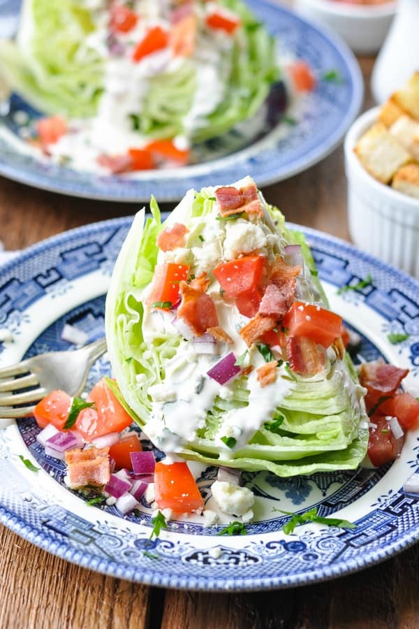 Front shot of classic wedge salad on a blue and white plate