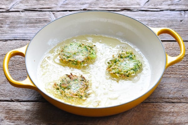 Frying zucchini fritters in a skillet