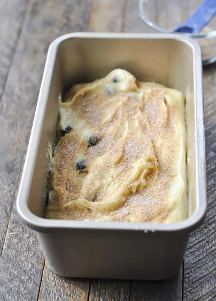 Blueberry bread batter in a loaf pan before baking.