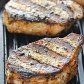 Side shot of one of the best grilled pork chop recipes on a grill pan.