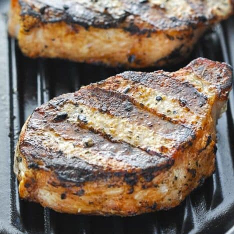 Close up square side shot of grilled pork chops.