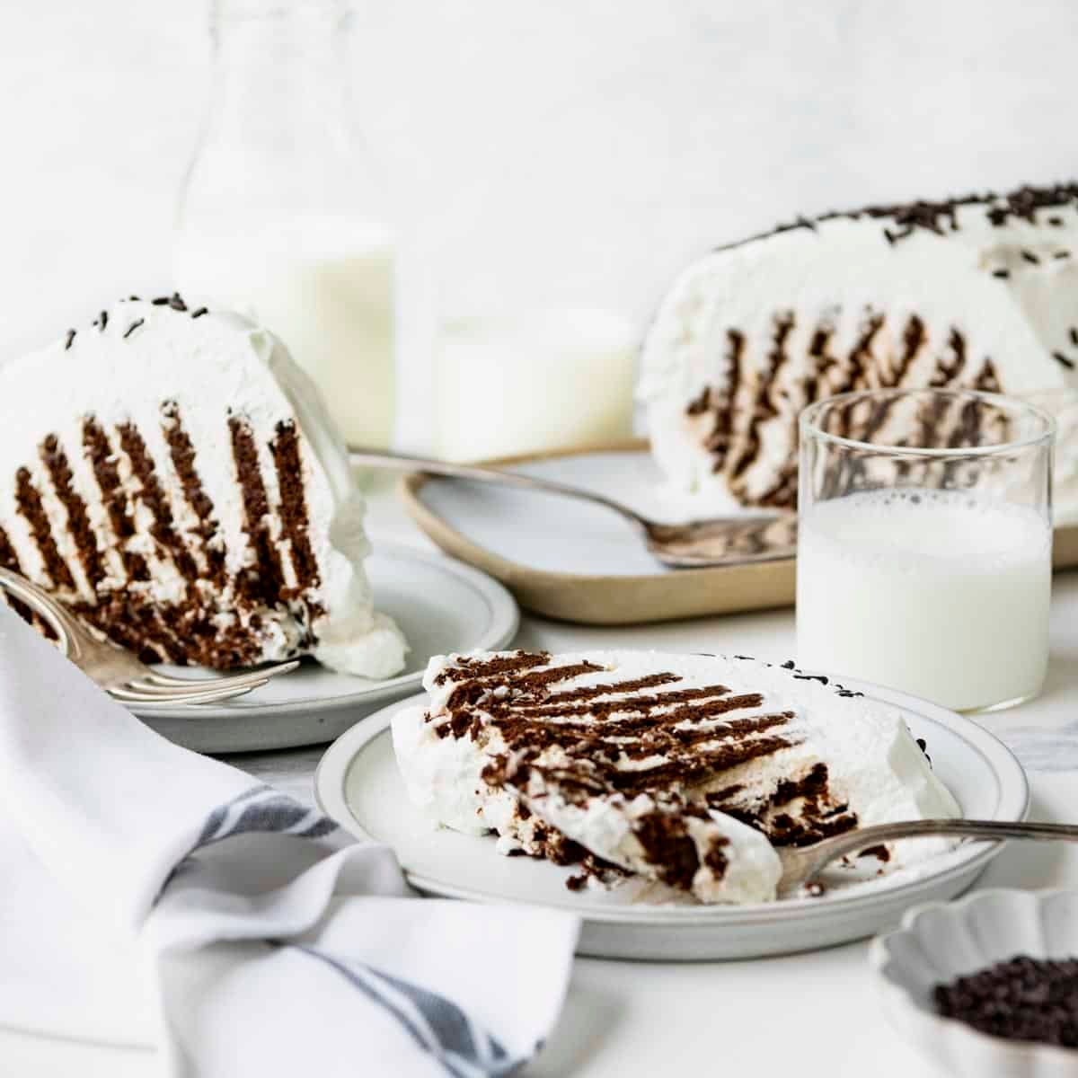 Side shot of a table of the best recipe for icebox cake.