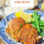 Front shot of blackened chicken breast on a plate with text overlay title at top