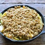 Adding topping to an apple crisp skillet before baking