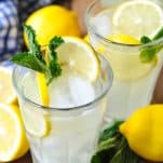 Overhead shot of glasses of homemade lemonade with a blue and white napkin nearby