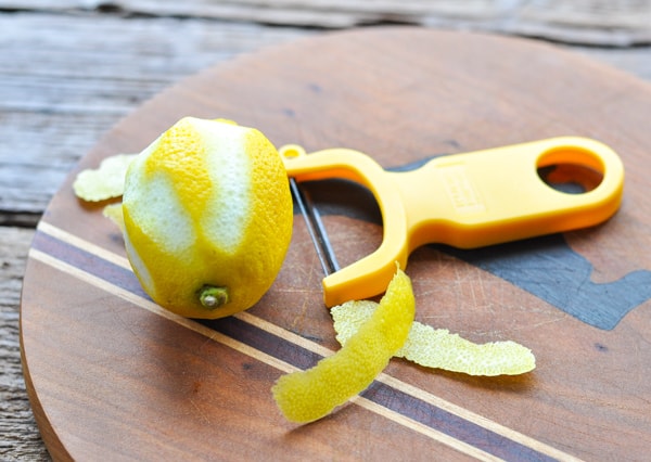 Zesting a lemon on a cutting board