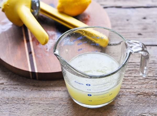 Freshly squeezed lemon juice in a glass measuring cup