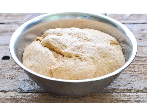 Whole wheat bread dough in a large bowl after rising