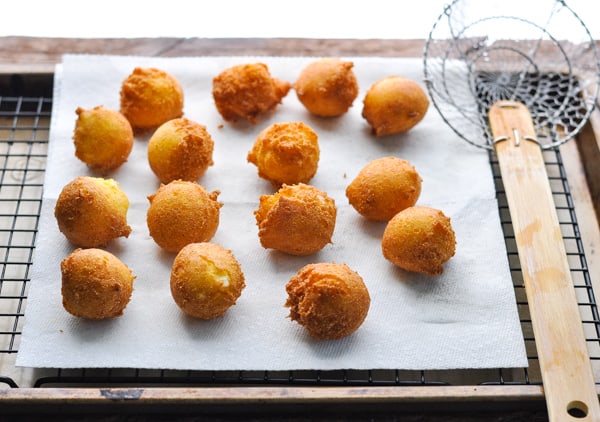 Draining hush puppies on paper towels before serving