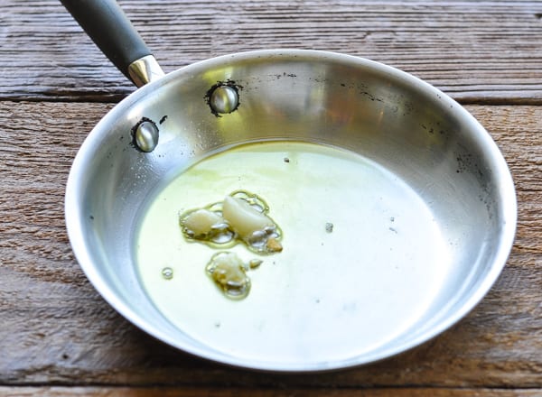 Making garlic infused olive oil in a skillet