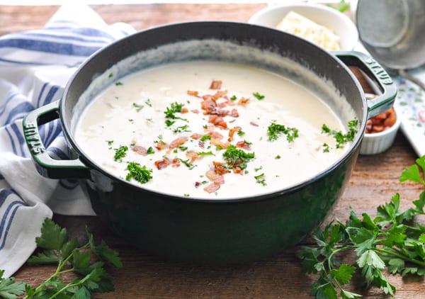 Horizontal shot of new england clam chowder in a green cast iron pot