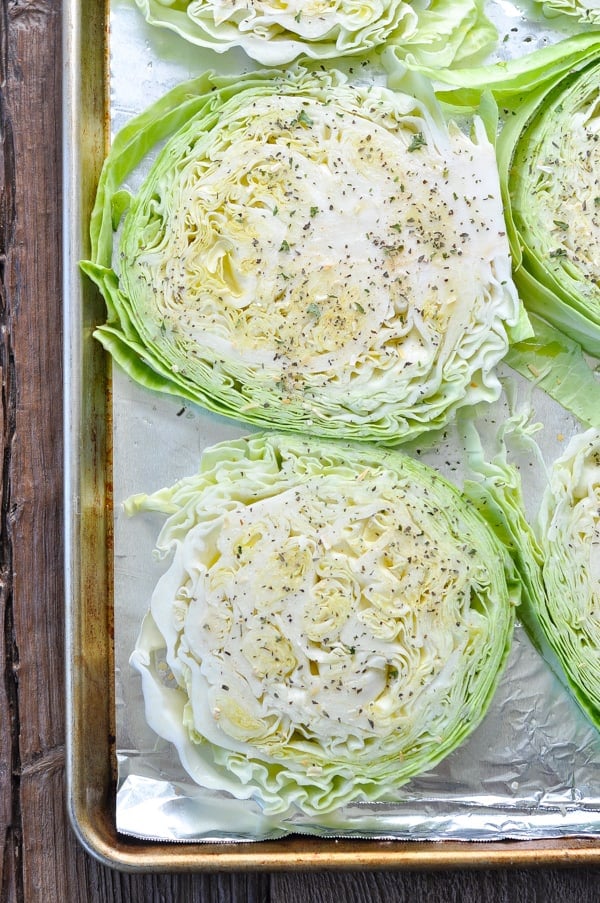 Overhead shot of cabbage slices on a baking sheet
