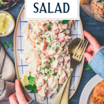 Hands holding a plate of seafood salad with text title overlay