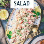 Overhead shot of a tray of the best seafood salad recipe with text title overlay