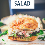 Seafood salad sandwich on a plate with text title overlay