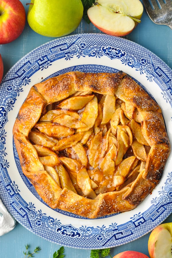 Close overhead image of an apple galette on a blue and white plate