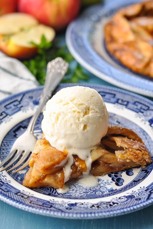 Close up front shot of apple galette slice served with vanilla ice cream