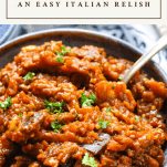 Close up shot of a bowl of homemade caponata with a text title box at the top of the image
