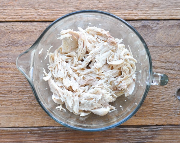 Shredded chicken in a glass measuring cup