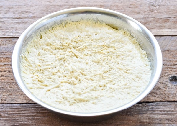 Focaccia dough in a large metal bowl