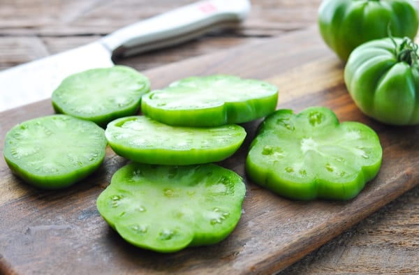 Sliced green tomatoes on a cutting board