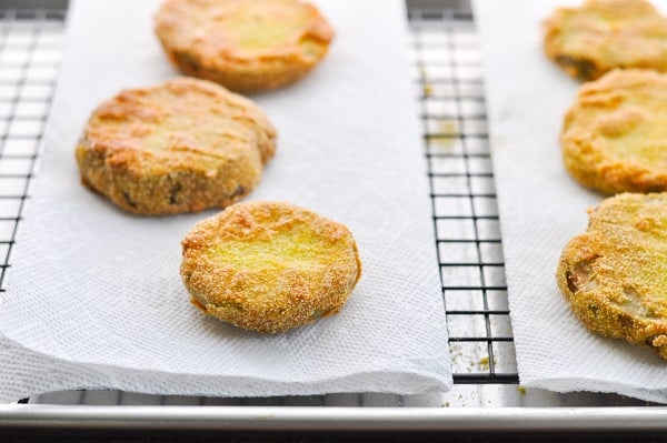 Draining fried green tomatoes on paper towels