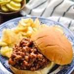 Homemade sloppy joes served with potato chips and pickles