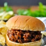 Front shot of homemade sloppy joes on a plate in front of a dark background