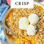 Overhead shot of a peach crisp with text title at top of image