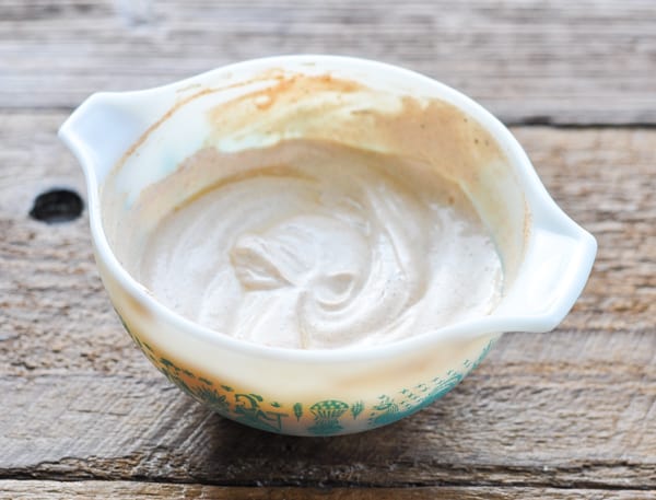 Sour cream marinade in a white bowl