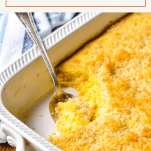 Close up shot of baked macaroni and cheese in a white dish with a text title at the top