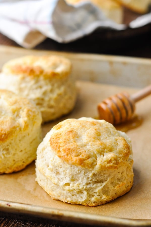 Freshly baked homemade Southern buttermilk biscuits on a parchment paper-lined baking tray.