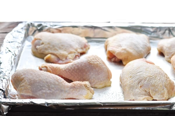 Chicken pieces on a baking sheet