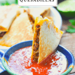 Front shot of a taco quesadilla in a bowl of salsa with text title at the top