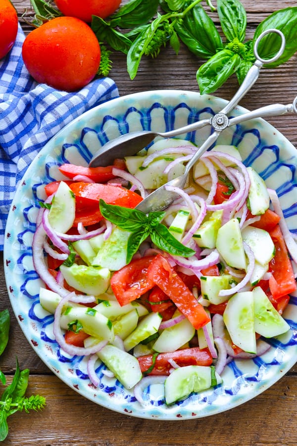 Overhead shot of a bowl of tomato cucumber red onion salad