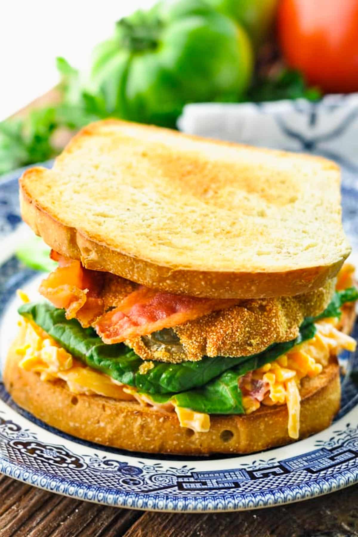Fried green tomatoes sandwich with pimento cheese and bacon.