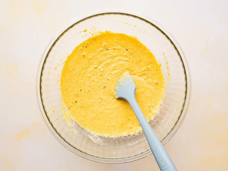 Batter for hush puppy recipe in a glass bowl.