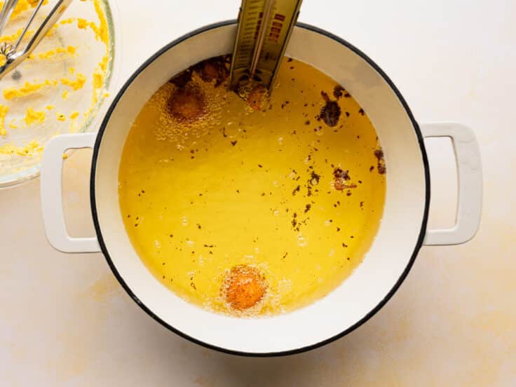 Frying hush puppies in a pot of oil.