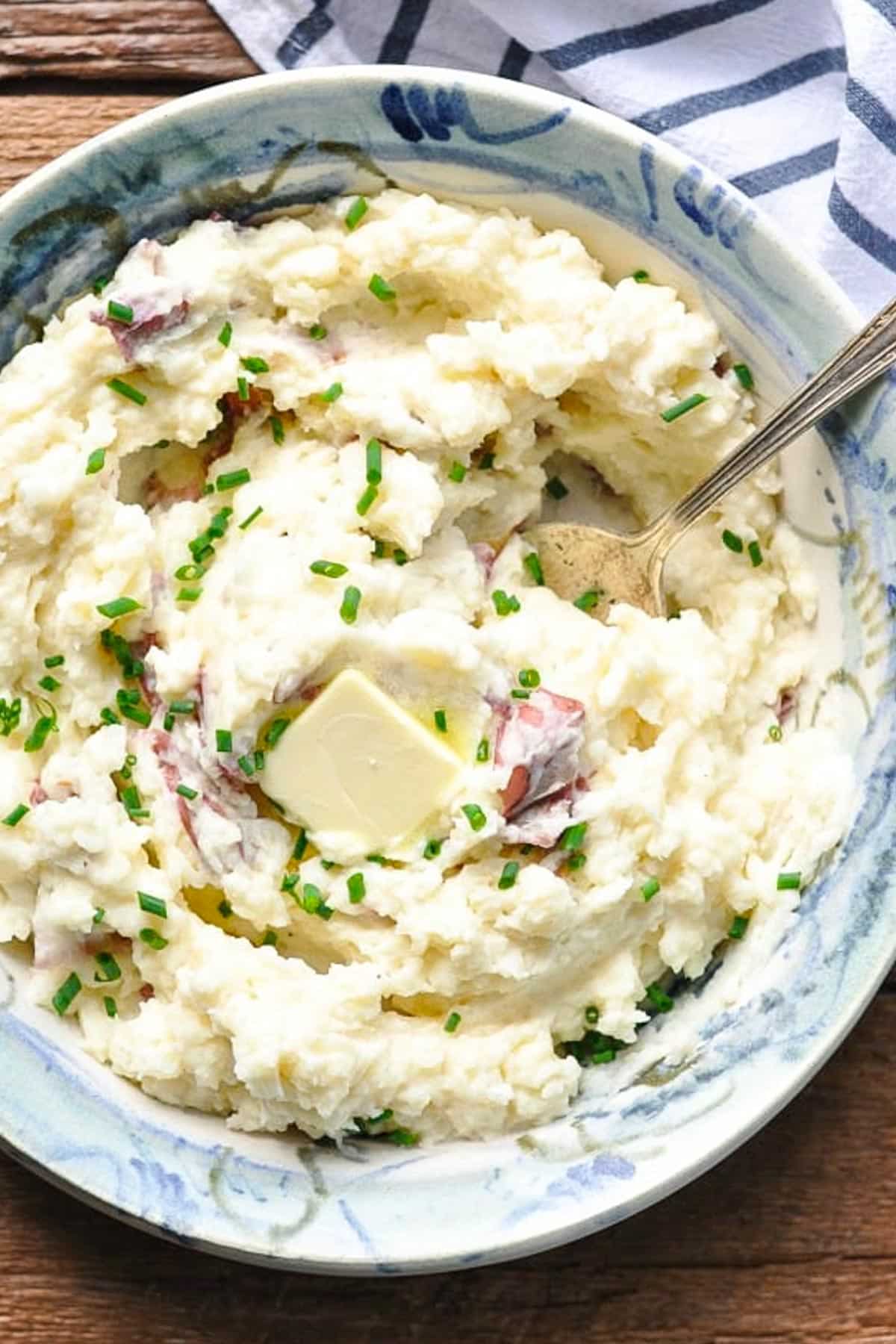 Close overhead shot of a bowl of homemade mashed red potatoes.