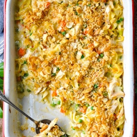 Overhead image of chicken noodle casserole from scratch in a white casserole dish with red trim