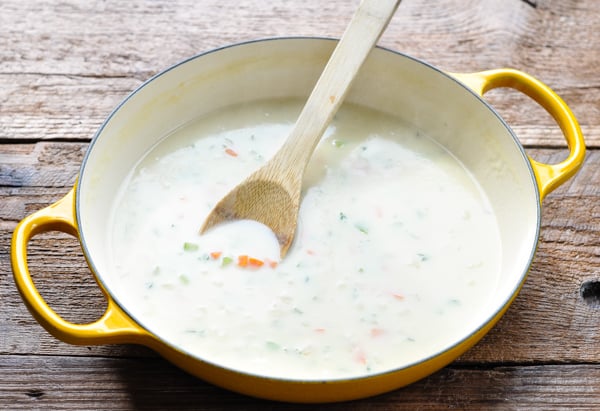 Cream sauce with vegetables in a large cast iron skillet