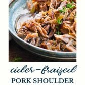 Bowl of apple cider pulled pork shoulder with text title at the bottom