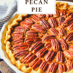 Close up shot of a homemade pecan pie recipe with a text title box at the top