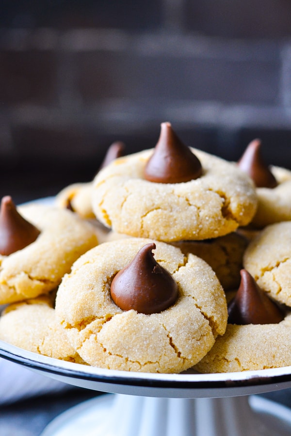 Close up shot of peanut butter blossoms recipe on a white tray with black trim
