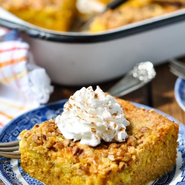 Side shot of a slice of pumpkin dump cake on a blue and white plate