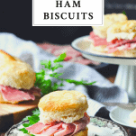 Front shot of ham biscuits on a wooden table with a text title box at the top