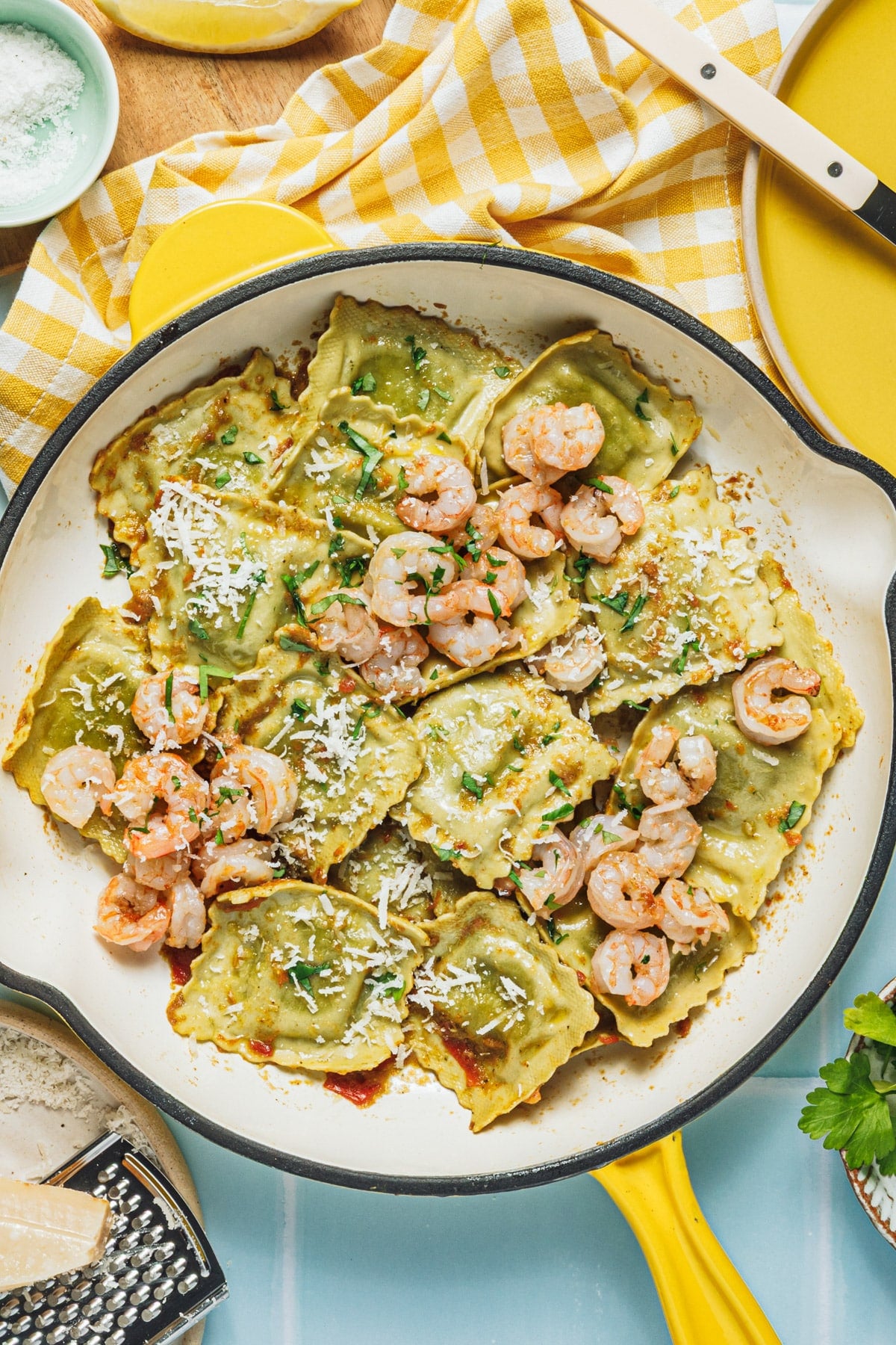Overhead shot of a skillet of shrimp with ravioli.