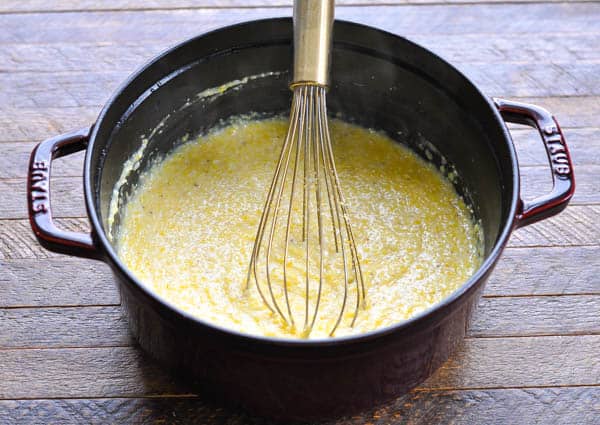 Whisking a pot of cheese grits